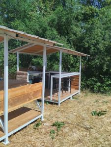 a gazebo with a table and chairs under it at La Grande Grange 89 in Saint-Martin-des-Champs