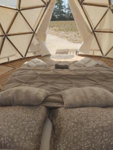 a bed in a tent in a room at La Grande Grange 89 in Saint-Martin-des-Champs