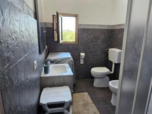 a bathroom with a sink and a toilet and a window at Villa Costa Viola in San Roberto +31 photos