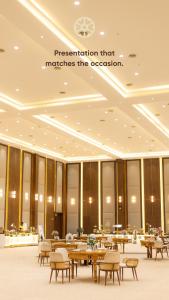 a restaurant that matches the occasion with tables and chairs at Kiwa Banquet & Hotel in Koba