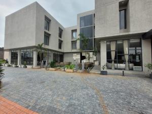 a building with a brick driveway in front of it at Kiwa Banquet & Hotel in Koba