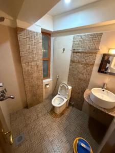 a bathroom with a toilet and a sink at Kathmandu Metro Boutique Hotel in Kathmandu