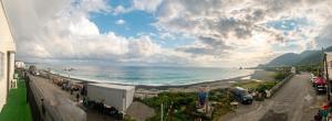 a view of a beach and the ocean on a cloudy day at Yawen Homestay 雅文民宿 in Lanyu