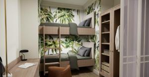 a room with a bunk bed with plants on the wall at Eendracht Hotel in Stellenbosch