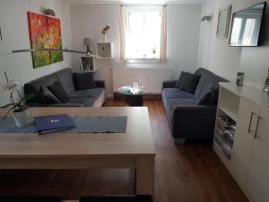 a living room with a couch and a table at Ferienhaus Nr. 10 in Buergstadt