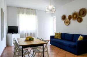 a living room with a blue couch and a table at Tenuta dei Normanni in Salerno