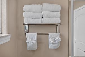 a stack of towels on a towel rack in a bathroom at Seaside Inn Monterey in Seaside +82 photos