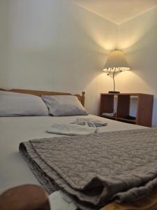 a bedroom with a bed and a lamp on a table at Comfortable stay - 2-bedroom apartment in Saint John
