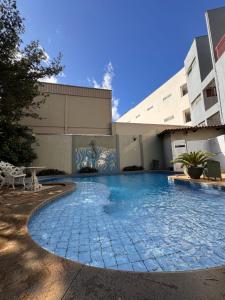 a swimming pool in front of a building at Hotel Veredas in Paracatu