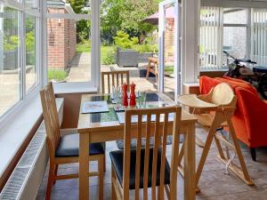 a dining room with a table and chairs at Pinecote in Bottesford