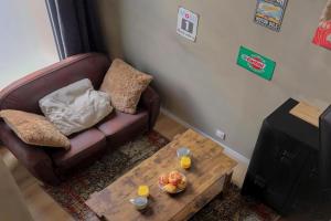 a living room with a couch and a coffee table at Lyon Cité Internationale - Loft Industriel Neuf in Caluire-et-Cuire