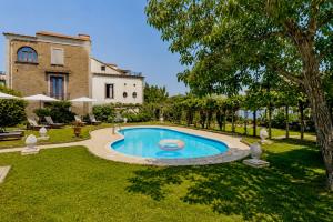 a swimming pool in the yard of a house at La Dimora 4: Charm and Quiet in SantʼAgata sui Due Golfi