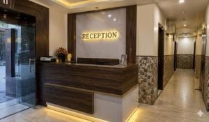 a reception desk in a lobby with a sign that reads reception at Hotel Aroha Stayz At Sector 44 Noida in Noida