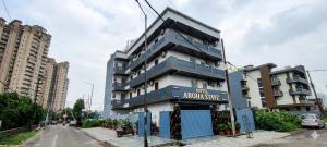 a building with a sign on the side of it at Hotel Aroha Stayz At Sector 44 Noida in Noida