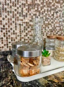 a counter with jars of food on a shelf at Premium House in Comodoro Rivadavia +8 photos