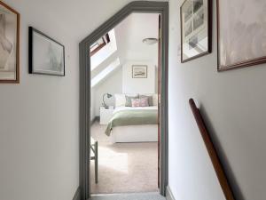 a hallway with a mirror leading to a bedroom at Lee Cottage - E4343A in Holy Island +9 photos
