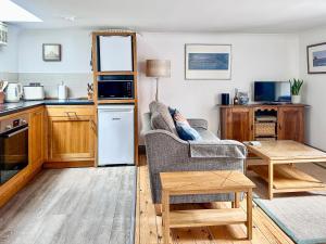 a living room with a couch and a table at Lee Cottage - E4343A in Holy Island