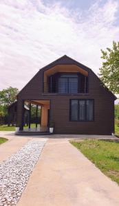 a brown house with a gambrel roof at George - Guest House Shekvetili in K'vemo Natanebi