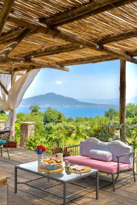 a patio with a table and a view of the ocean at La Dimora 4: Charm and Quiet in SantʼAgata sui Due Golfi