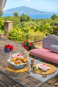 a table with two plates of food on a deck at La Dimora 4: Charm and Quiet in SantʼAgata sui Due Golfi