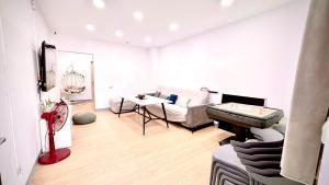 a living room with a piano and a couch at 小邱民宿 in Anping