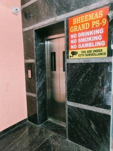 an elevator with a sign on the side of a building at Bheemas Grand Ps9 in Srikalahasti +10 photos