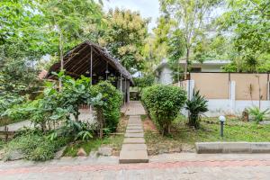 a house with a staircase leading up to a house at Aavaranaa Farmstay in Kanakapura