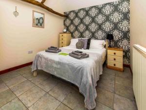 a bedroom with a bed with towels on it at Thyme - E4485 in Catfield