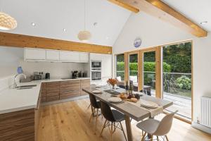 a kitchen and dining room with a table and chairs at House 32 in Looe