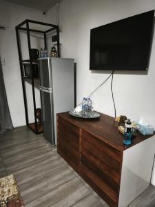 a living room with a tv and a refrigerator at Maphango Farms BnB in Alice