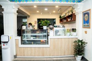 a restaurant with a counter with plants in it at Boudha Mandala Hotel in Kathmandu