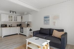 a living room with a couch and a table at Løkken Badehotel Apartments in Løkken