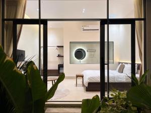 a bedroom with a bed through a glass door at Samphia Homestay in Nguyệt Hòa +33 photos