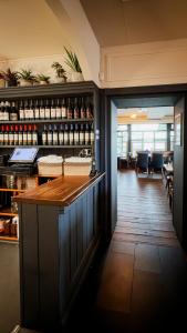a bar in a restaurant with wine bottles at Kildare House Hotel in Kildare