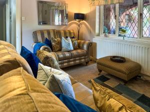 a living room with a couch and a chair at The Old Barn-E1425 in Addlethorpe