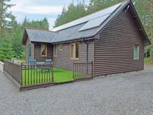a house with a solar panel on top of it at Park Lodge in Strachan