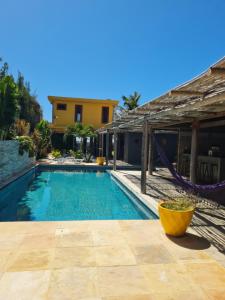a swimming pool in front of a house at Casa Bea in Fortim