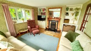a living room with a couch and a fireplace at River Views, Private Fishing & 9 min Train to York in Ulleskelf