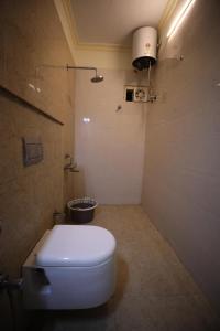 a bathroom with a white toilet and a shower at StarlightHotels ARResidency in Chennai +14 photos