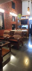 a room with a table and some chairs and a table at Leela Villa - Ancient Redstone Escape in Panchgani