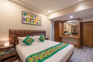 a bedroom with a large bed and a mirror at Treebo Planet Mount Near US Consulate Anna Salai in Chennai