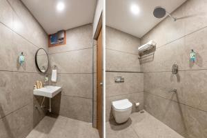 a bathroom with a shower and a toilet and a sink at Treebo Planet Mount Near US Consulate Anna Salai in Chennai +32 photos
