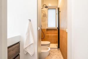 a small bathroom with a toilet and a window at Casa Eos in Bari +32 photos