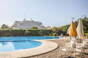 a swimming pool with chairs and umbrellas at Casa Eos in Bari