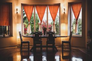 a dining room with a table and chairs and a window at Hide Away in a Private Countryside Villa in Prestranek +19 photos