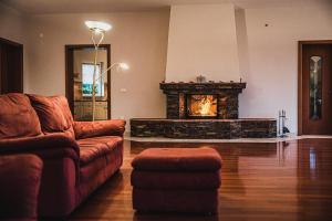 a living room with a couch and a fireplace at Hide Away in a Private Countryside Villa in Prestranek
