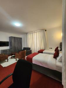 a hotel room with two beds and a couch at GRANADA HOTEL NAIROBi in Nairobi +21 photos