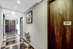 a hallway with a sign that says on the wall at Super Townhouse All In One in kolkata +36 photos