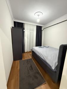 a small bedroom with a bed and a window at suite palace in Kapullu +3 photos