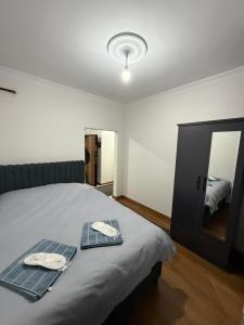 a bedroom with a bed with two plates and a mirror at suite palace in Kapullu